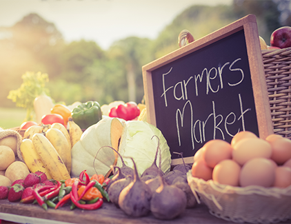 Fresh produce stand at a farmers market, symbolizing retail & shopping locations ideal for ATM placement services such as Turnkey ATM Programs, ATM sales, and cashless ATM solutions.