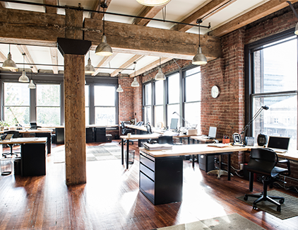 Contemporary office space with natural light and tech-ready workstations, illustrating prime professional and educational service centers for cutting-edge ATM solutions.