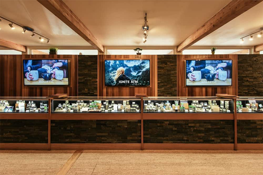 Interior of a cannabis dispensary showcasing a glass display case with a premium selection of cannabis products.
